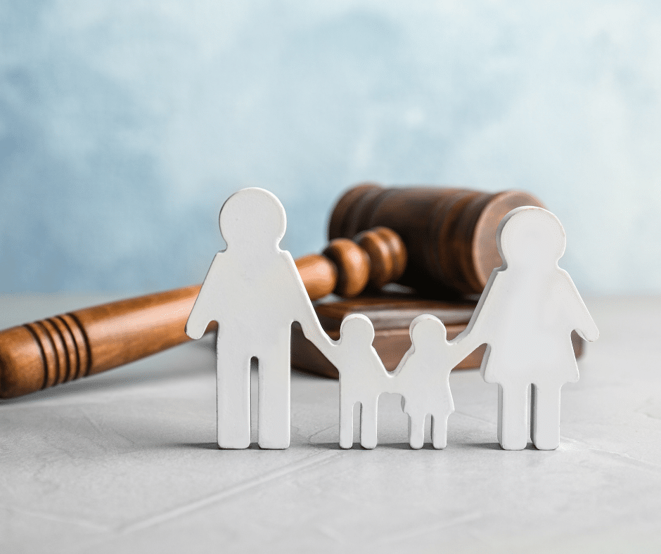 Cutout of two parents and two kids next to a gavel on a table, representing Semenza Law's family law services.
