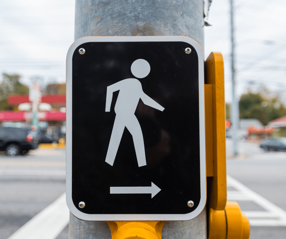 Crosswalk sign, symbolizing pedestrian safety and the focus of Semenza Law's pedestrian accident legal services.